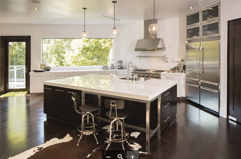 The kitchen island in this home designed by Castlerock Builders acts as a social hub.
