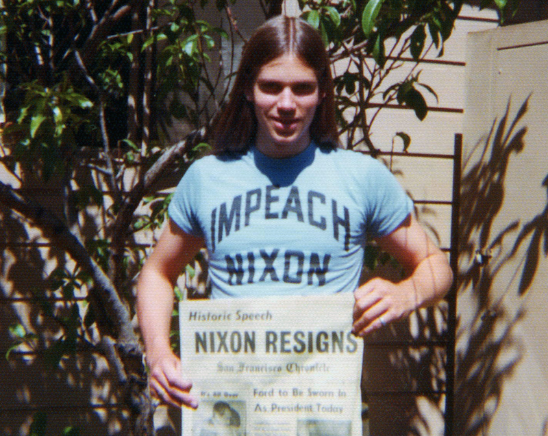 young man wearing Impeach Nixon T-shirt and holding SF Chronicle newspaper with Nixon headline