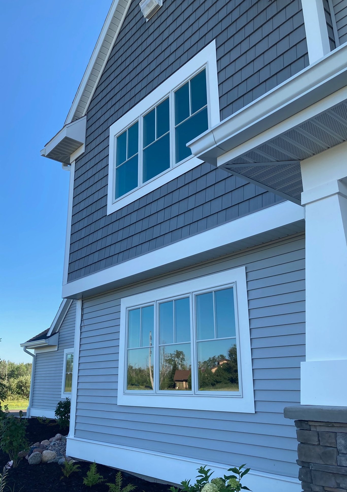Foundry siding on the second floor blends with the first-floor hues to create a soothing-yet-elegant multi-textured look.