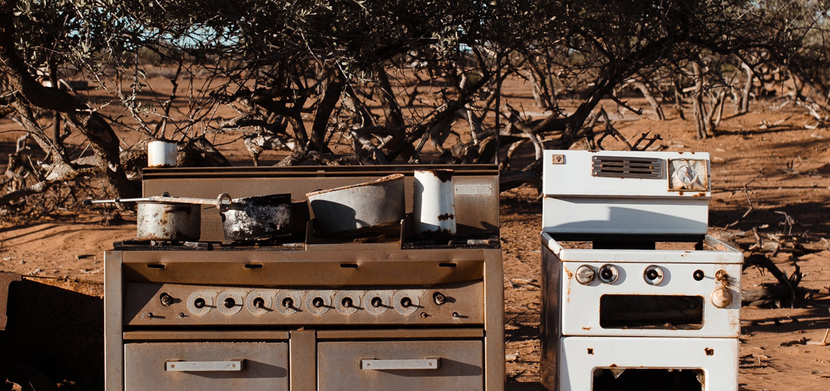 Old gas stove in desert stock image
