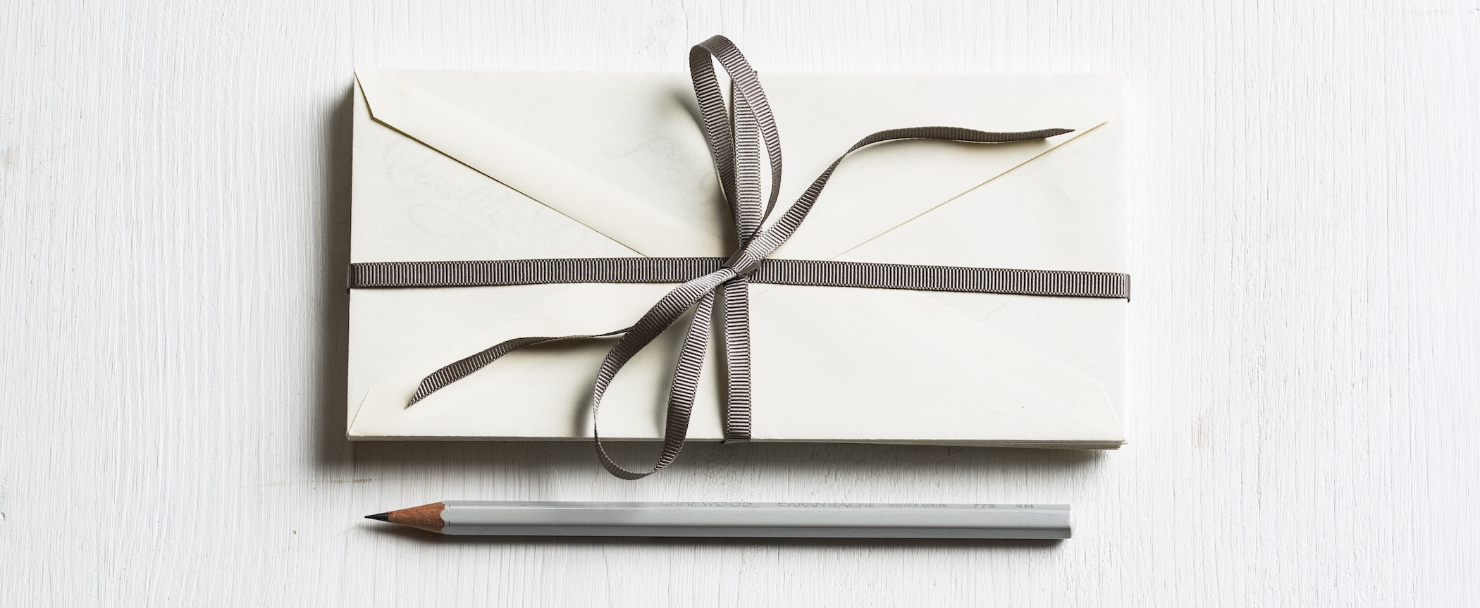 Envelopes with ribbon and pencil