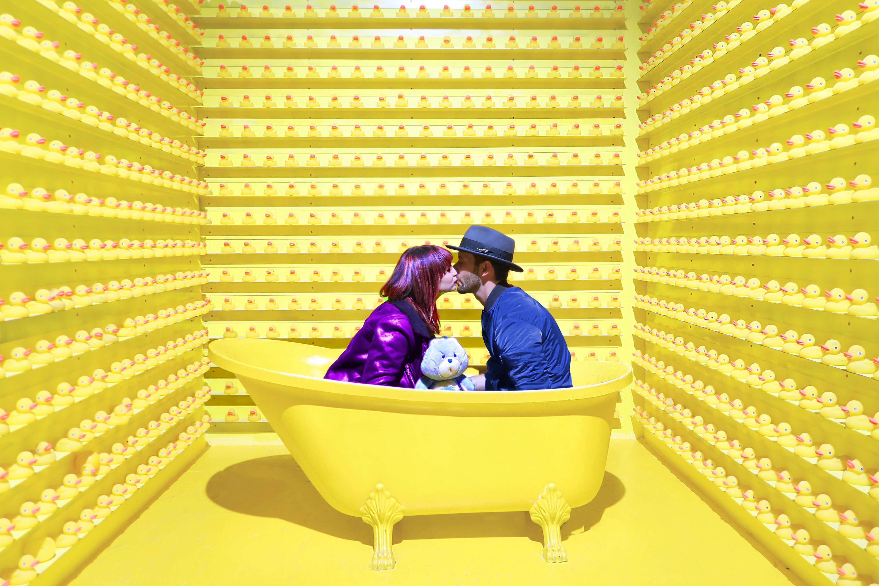 Couple in bathtub with care bear plush