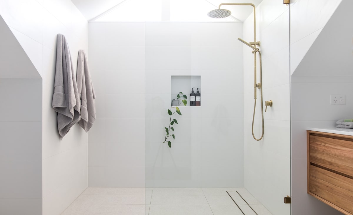 Large glass shower in white modern bathroom