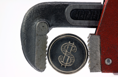 Adjustable wrench squeezing a coin
