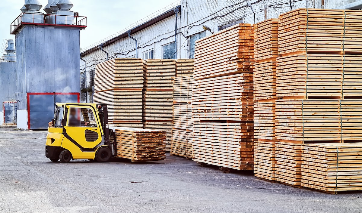 Lumber pallets being transported in warehouse