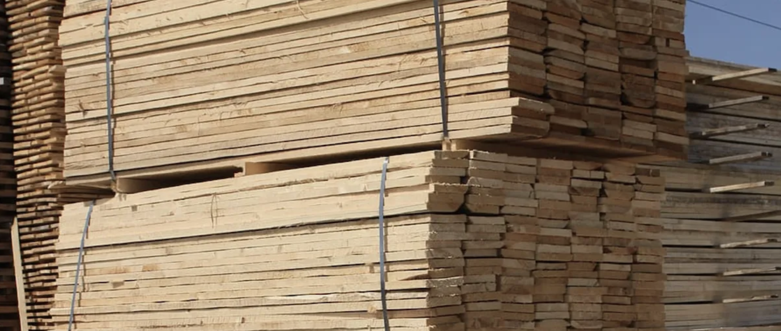 https://www.probuilder.com/sites/default/files/lumber-stacked-in-lumberyard.png