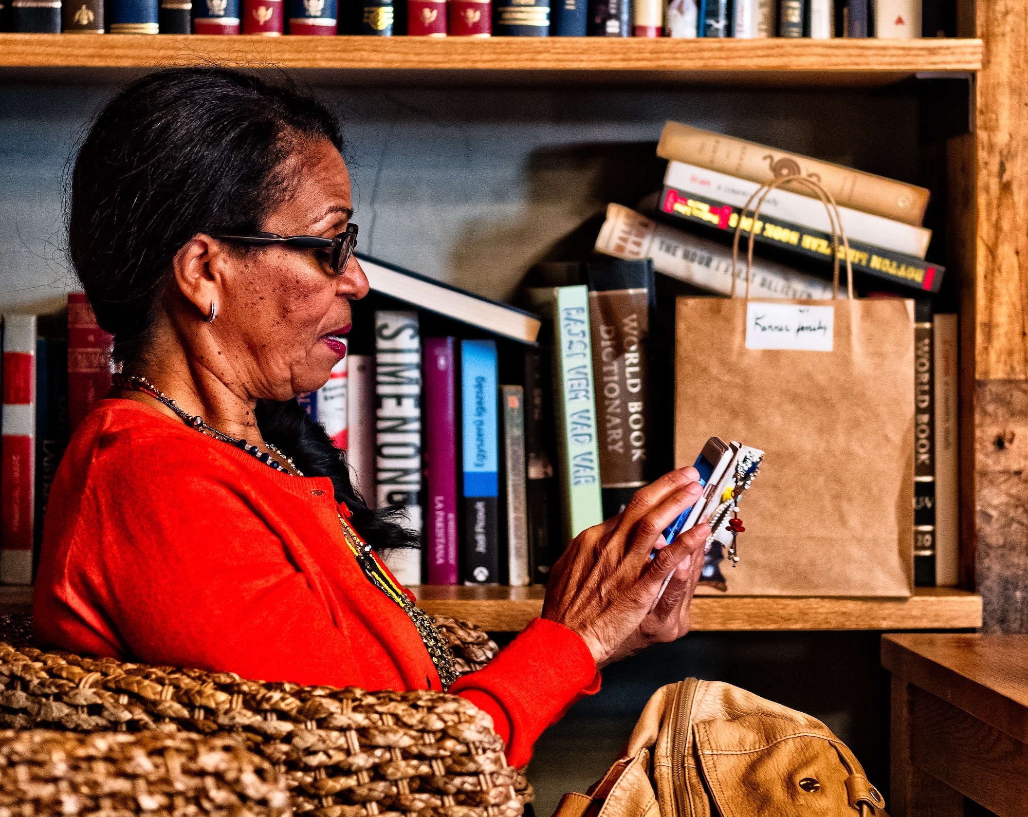 Woman using mobile device in a bookstore