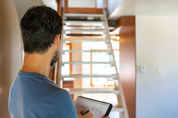 home inspector assessing staircase and other features in home