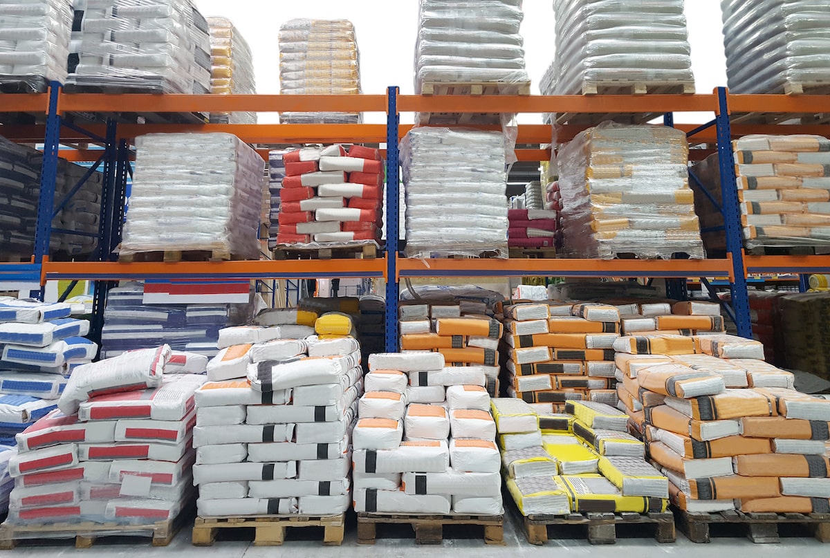 Bags of cement on shelf in building products warehouse