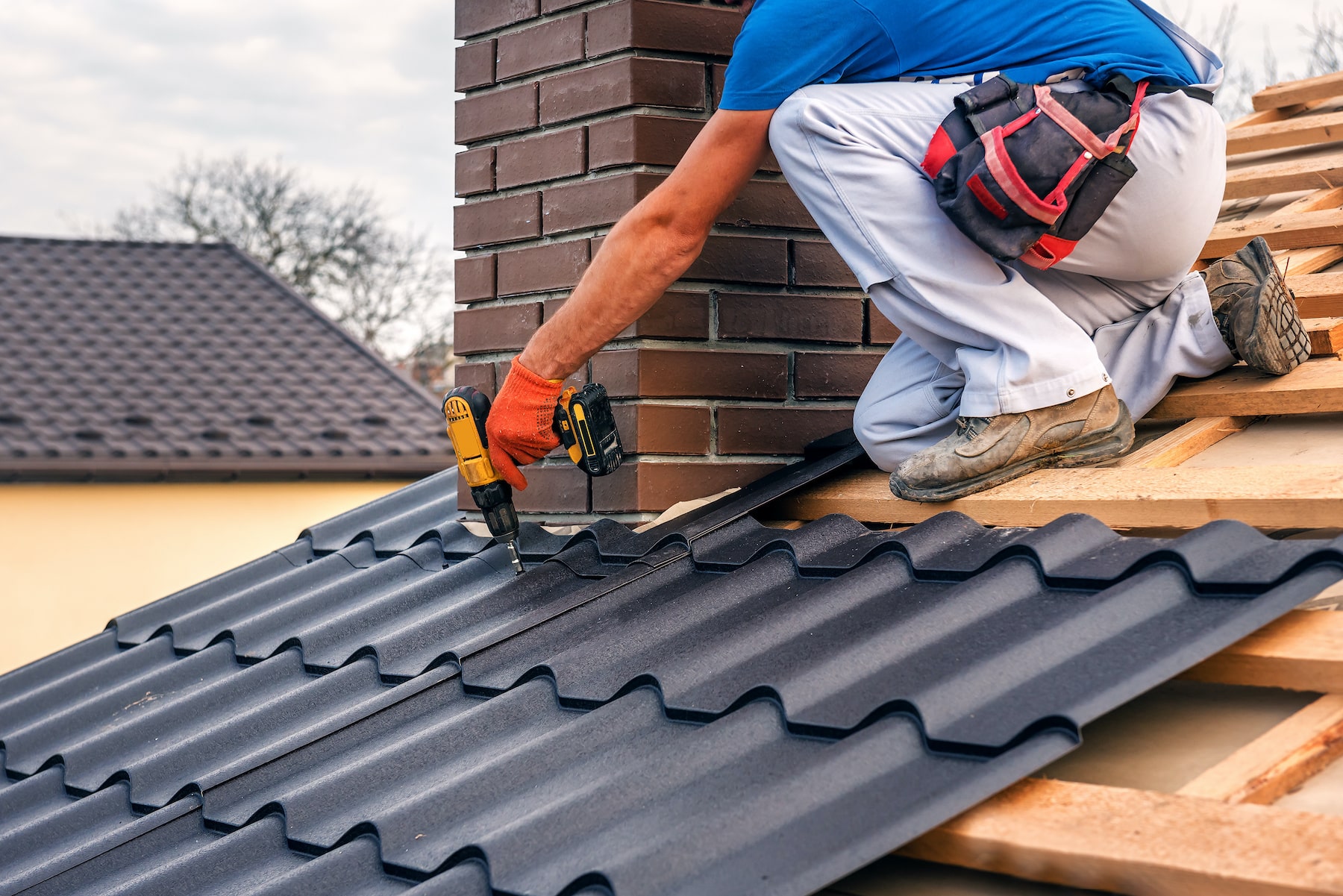 Worker fastening fire-resistant metal roof