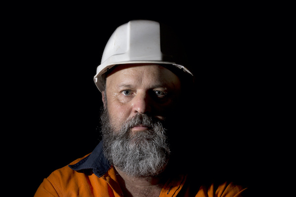 bearded middle-aged construction worker wearing hard hat