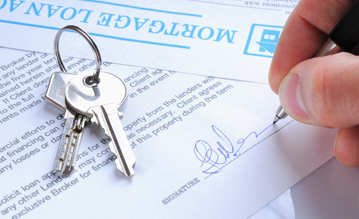 Mortgage loan paperwork with house keys