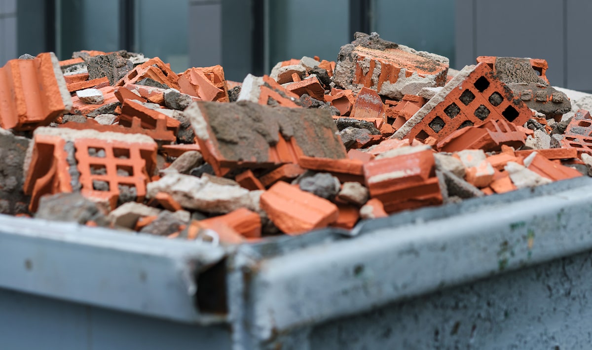 Bricks from demolition project in bin