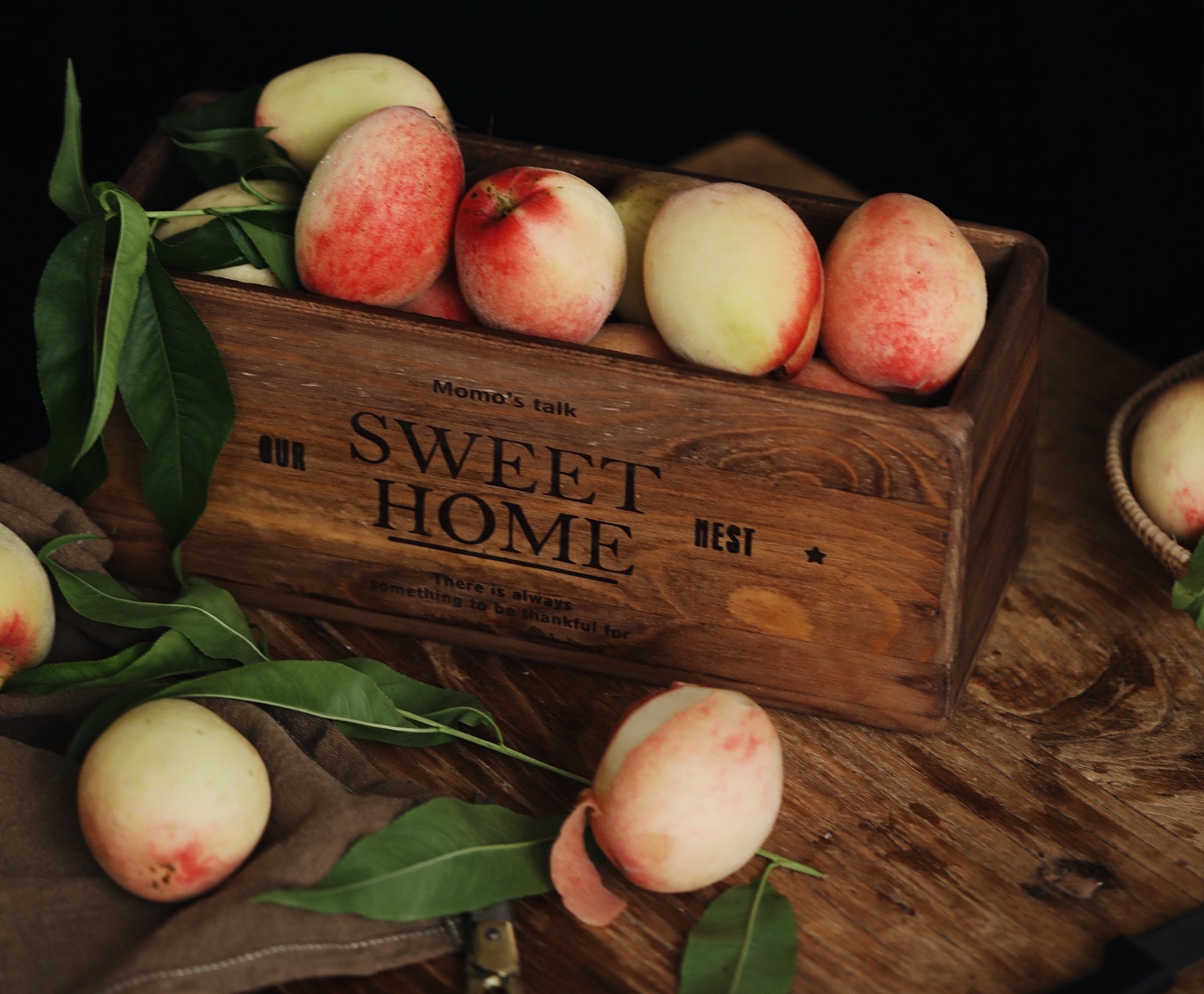 Box of peaches on a table