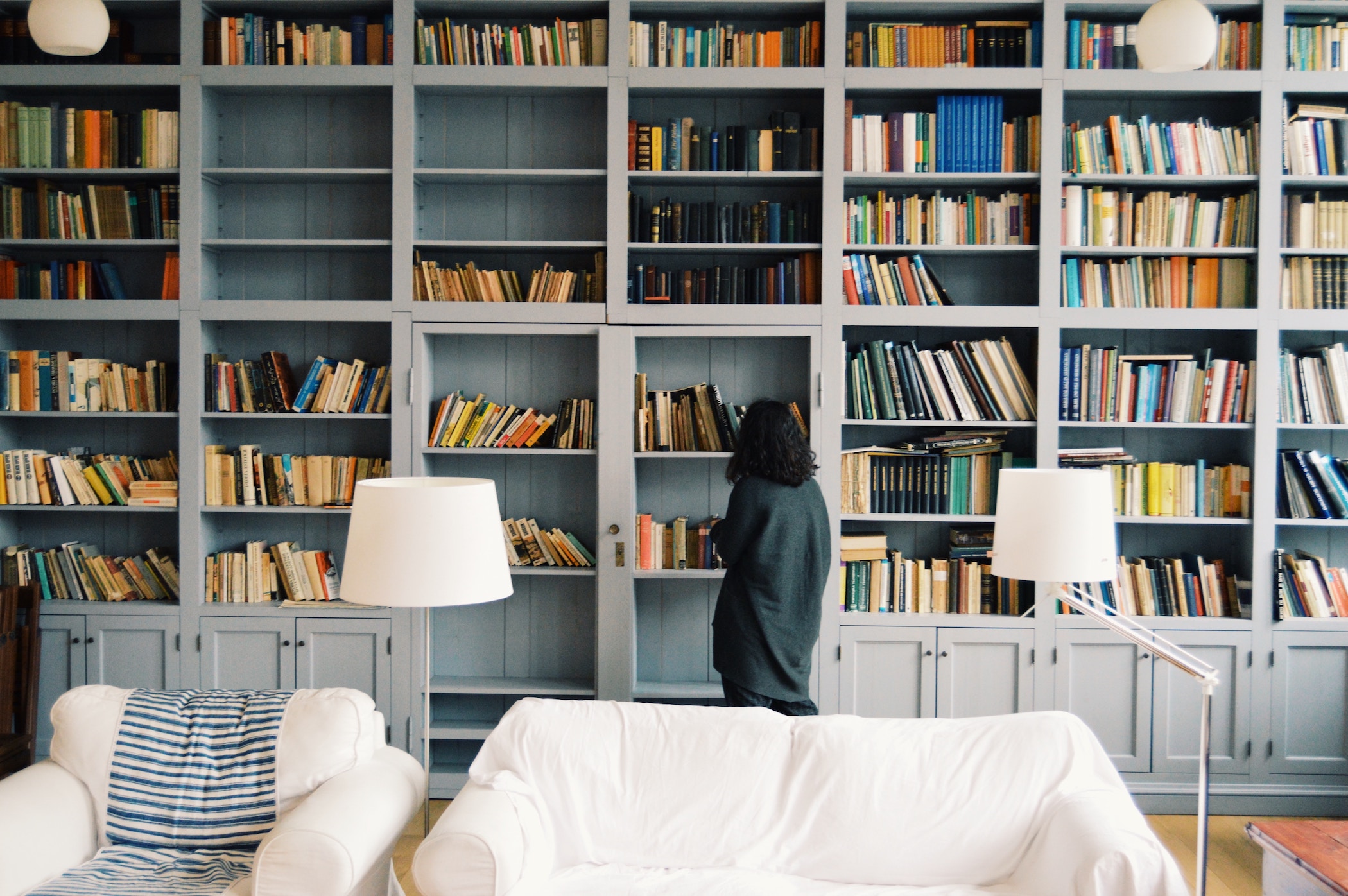 Woman at built-in bookcase