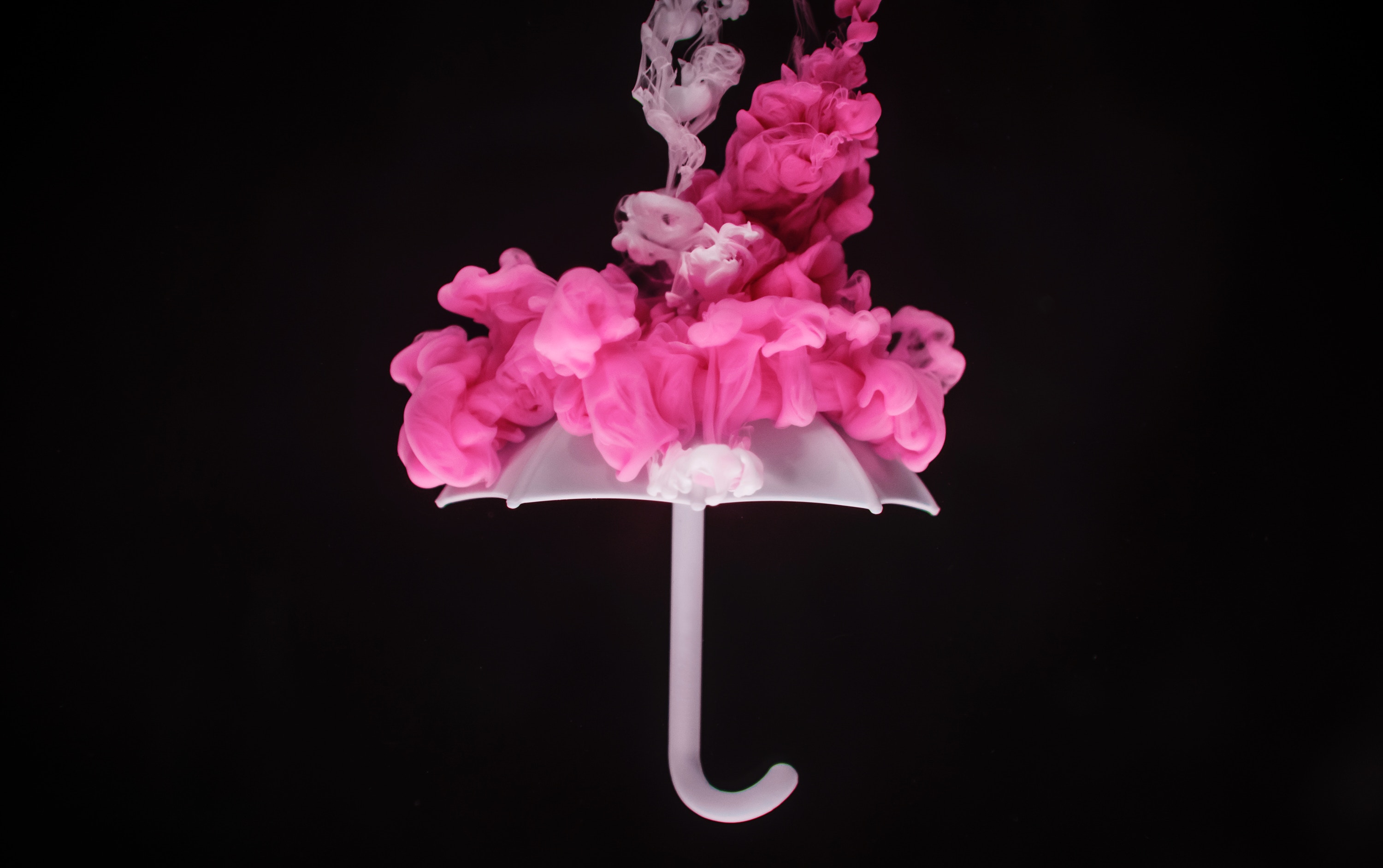 Umbrella with pink smoke on top