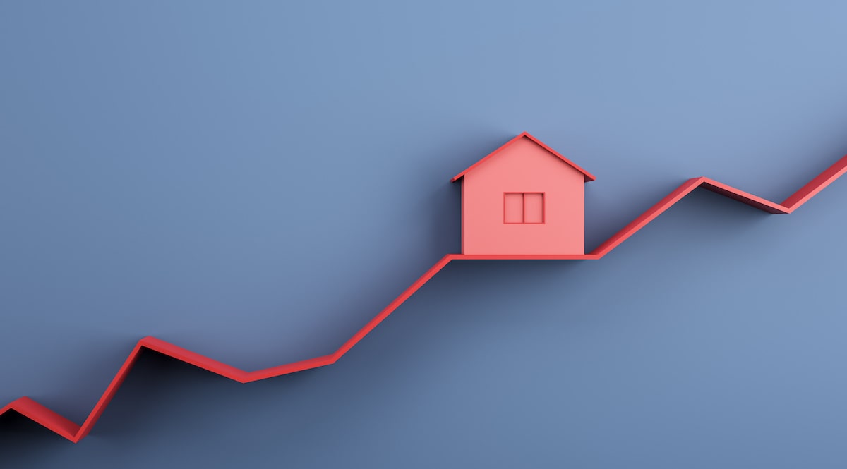 Gray and red rising line graph with red house in center