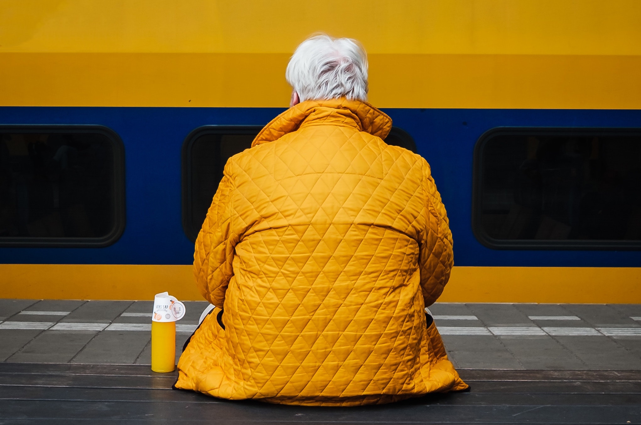 Senior man sitting at train station