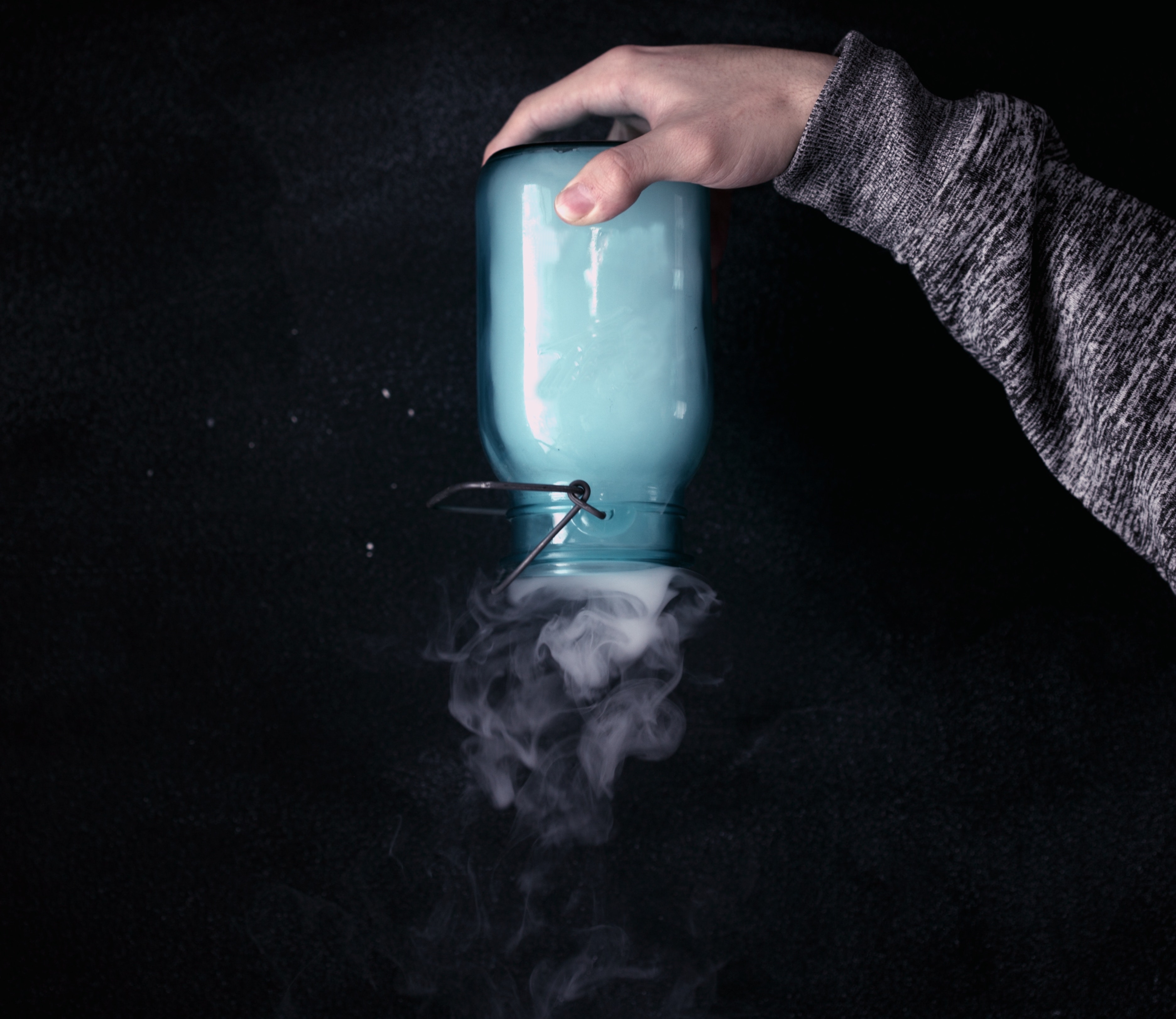 Person holding jar of smoke