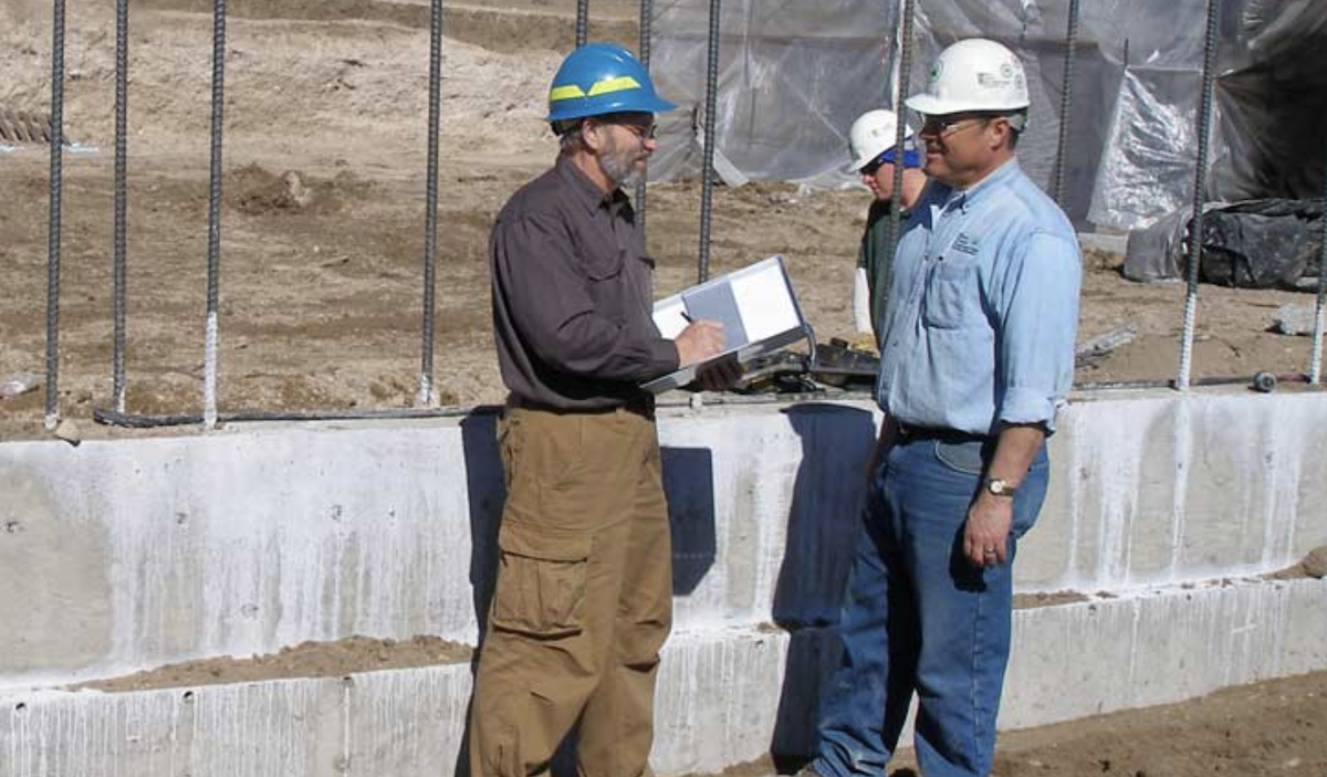 site superintendent discusses construction progress with building crew