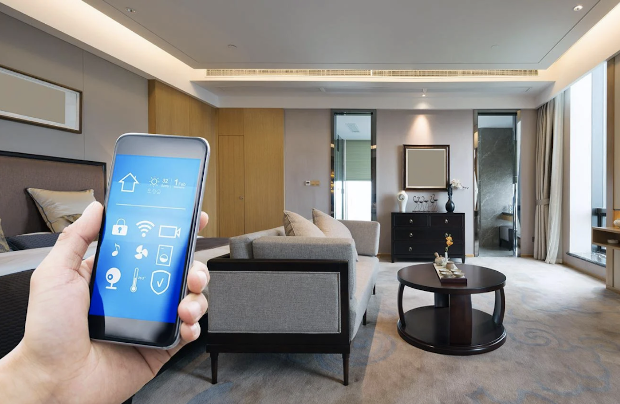 hand holding smartphone in a smart home