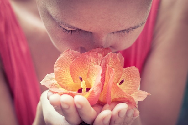 Woman_smelling_flower