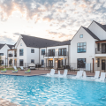 Houses grouped around the central pool at multifamily rental development Hermosa Village in Texas