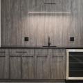 The faux range hood above the countertop is created by LED lighting