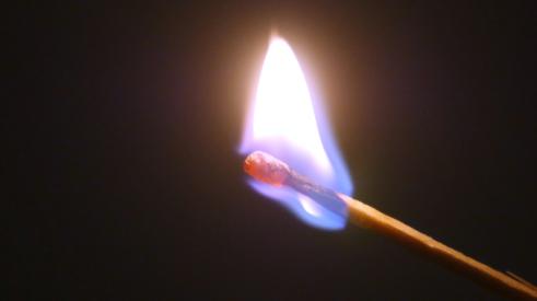 Match stick on fire with blue flame