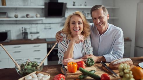 55 year old couple happy in the kitchen
