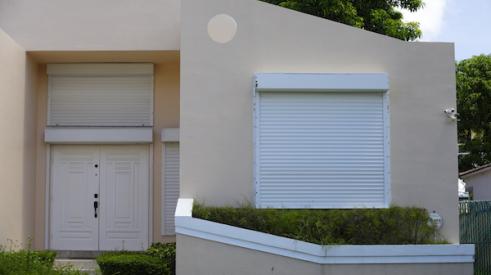 Home with hurricane shutters on window