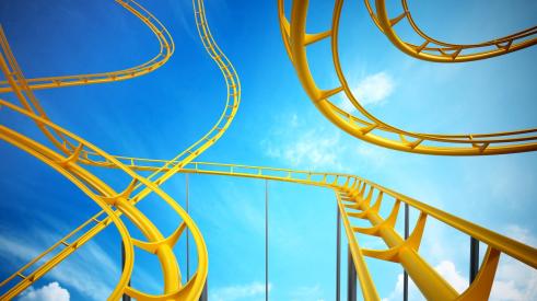 Yellow rollercoaster with blue sky in background
