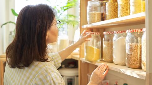 Woman looking in kitchen pantry
