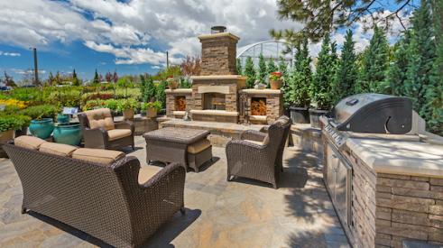 Outdoor space with kitchen, fireplace, and furniture 