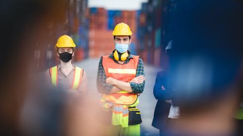 Two construction workers with face masks on