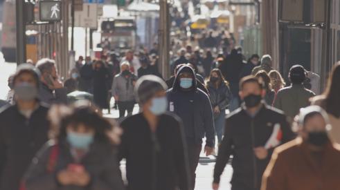 People walking in city with masks