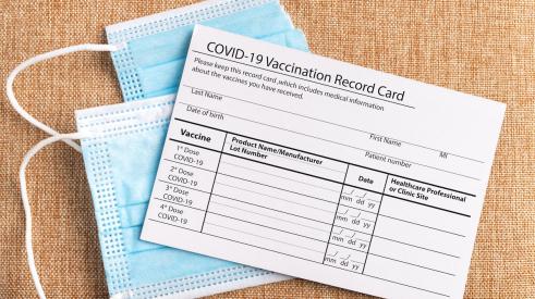COVID-19 vaccine card and masks