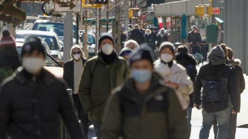 People walking in city wearing masks