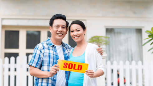 Asian couple who have just bought a new home