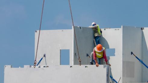 Workers installing concrete panels