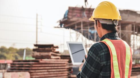 Construction worker with computer tablet