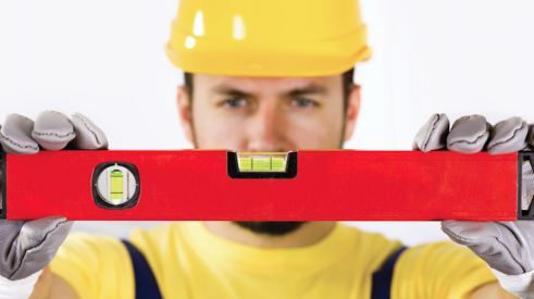 Construction worker holding spirit level