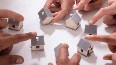 Fingers on models of homes for multiple homebuyers