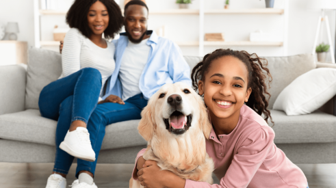 Happy family at home with their pet dog