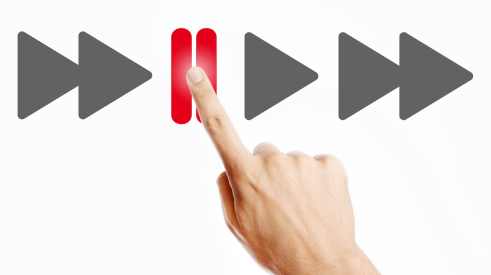Finger pressing red pause button