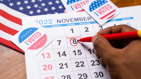 An 'I voted' sticker is on top of a November 2022 calendar.