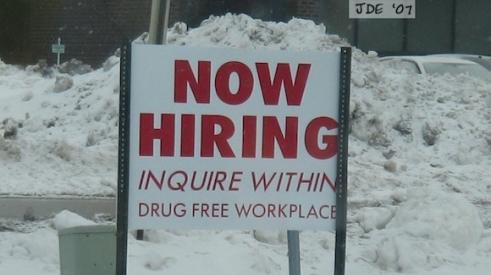 "Now hiring" sign to attract new employees.