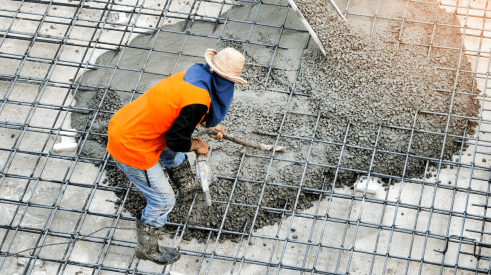 Pouring concrete slab on construction jobsite