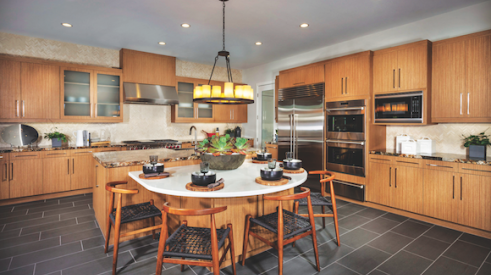 The warm wood cabinets and slate-gray flooring in this kitchen at Truewind, in Huntington Beach, Calif., by TRI Pointe Homes, is a recent example of the transitional look.