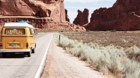 Volkswagen van on desert canyon road. 